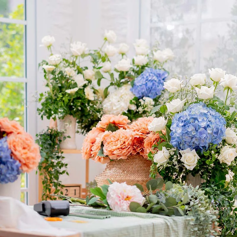 selection of faux flowers for backdrop creation