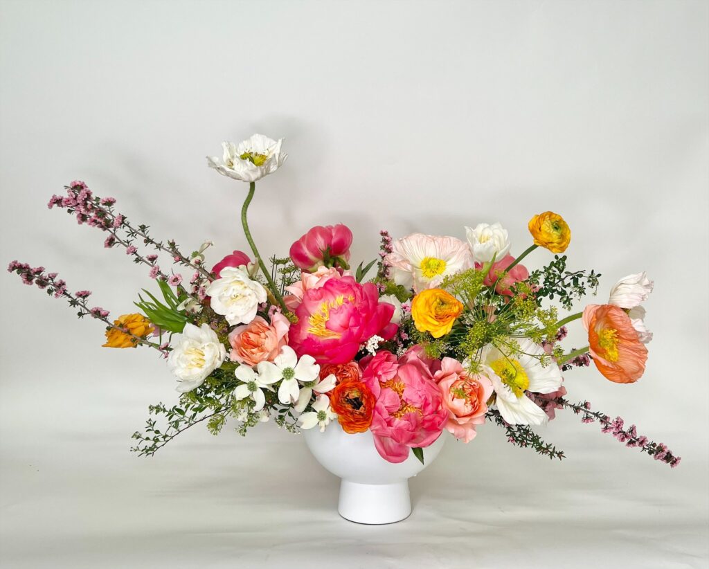 tiny vase holding large bloom top-heavy