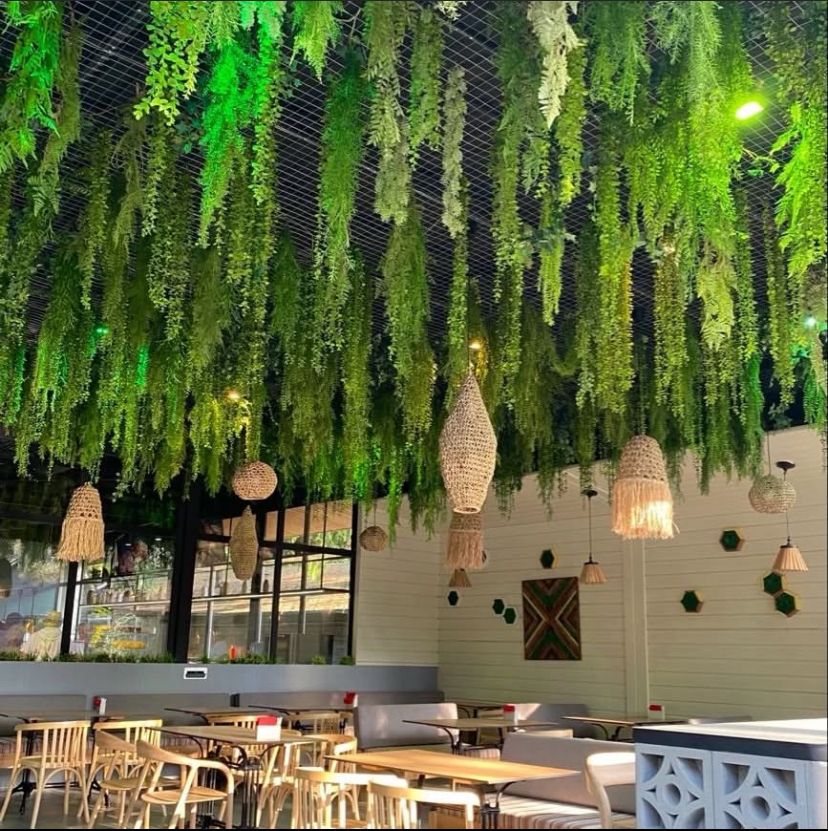 Faux greenery ceiling across co-working space ceiling