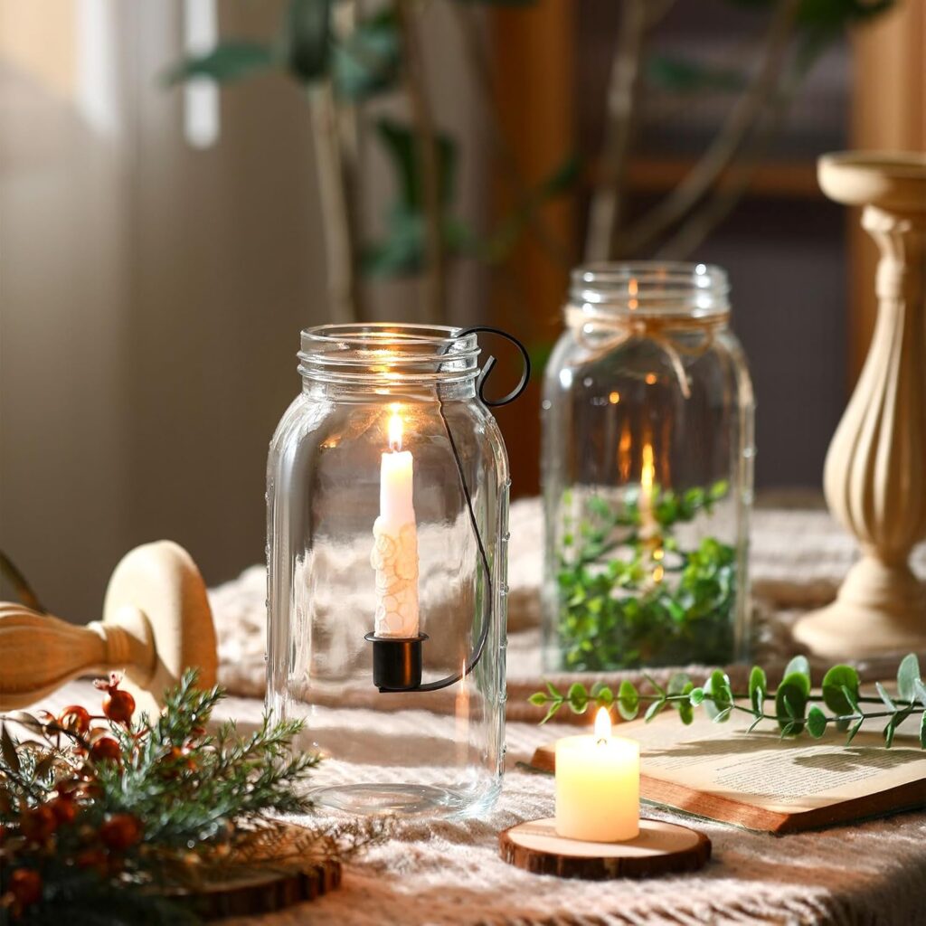 mason jar candle holder insert with candle and faux greenery on dining table with floral arrangement