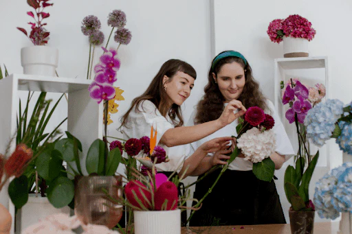 warehouse worker with clipboard inspecting artificial flower inventory to plan when to clean silk flowers
