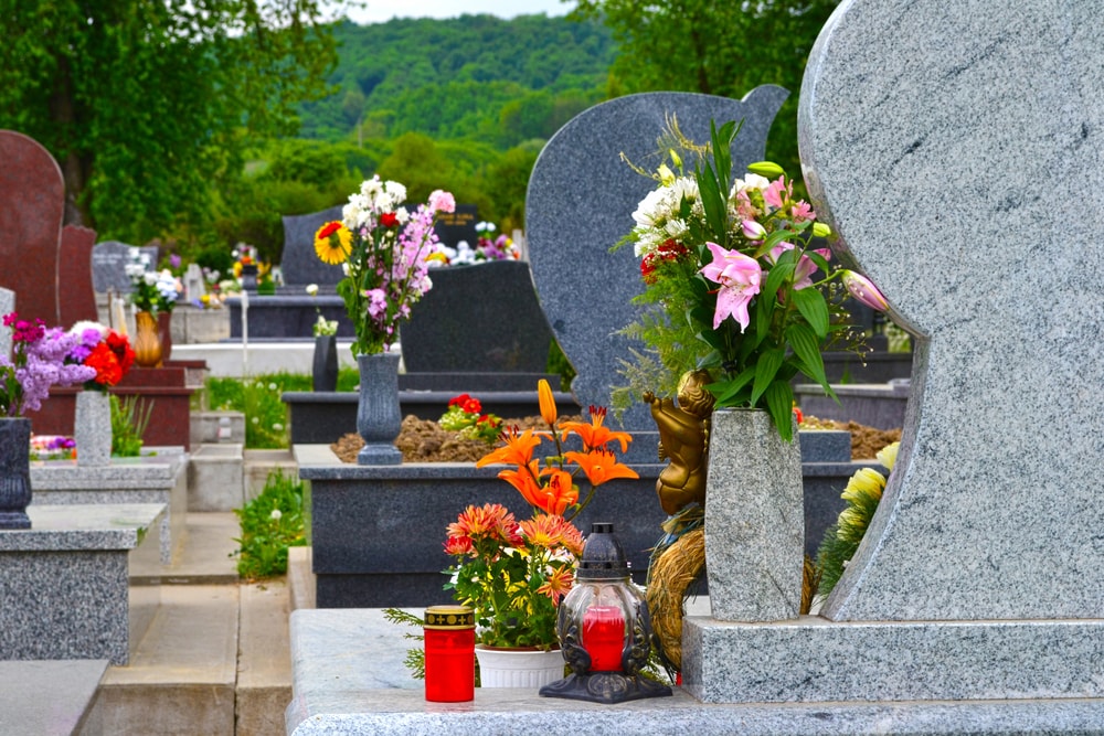 why do people put flowers on graves meaning tradition memorial flowers