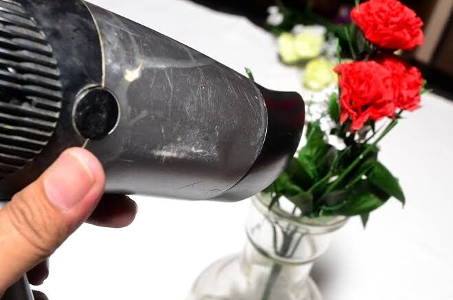 compressed air for hard-to-reach silk flower dust removal