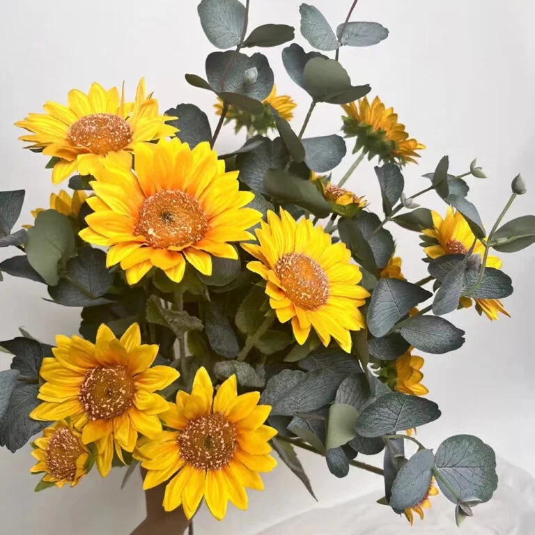 Yellow artificial sunflower arrangement with eucalyptus leaves