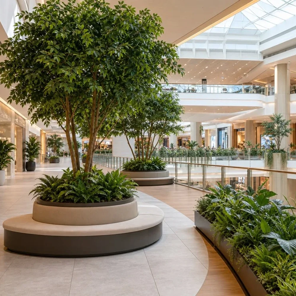 Large artificial trees and greenery in a shopping mall atrium
