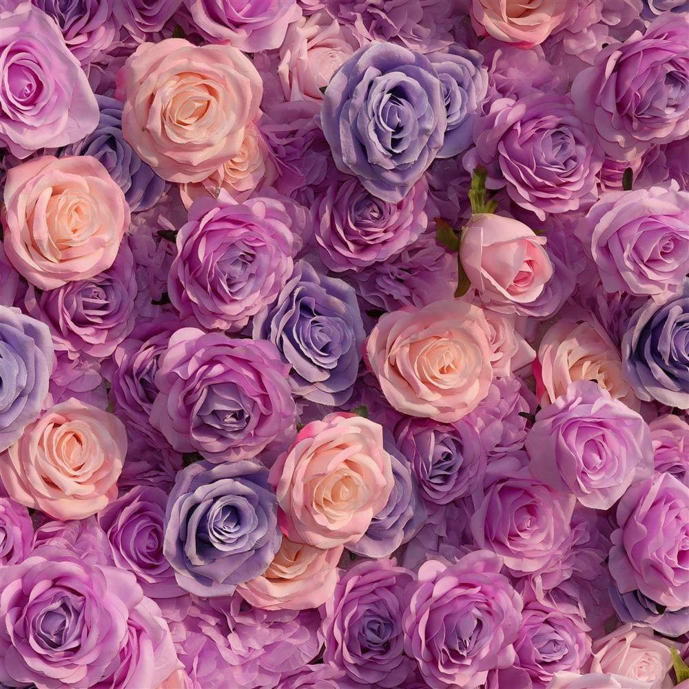 Close-up of purple and pink roses on an artificial flower wall