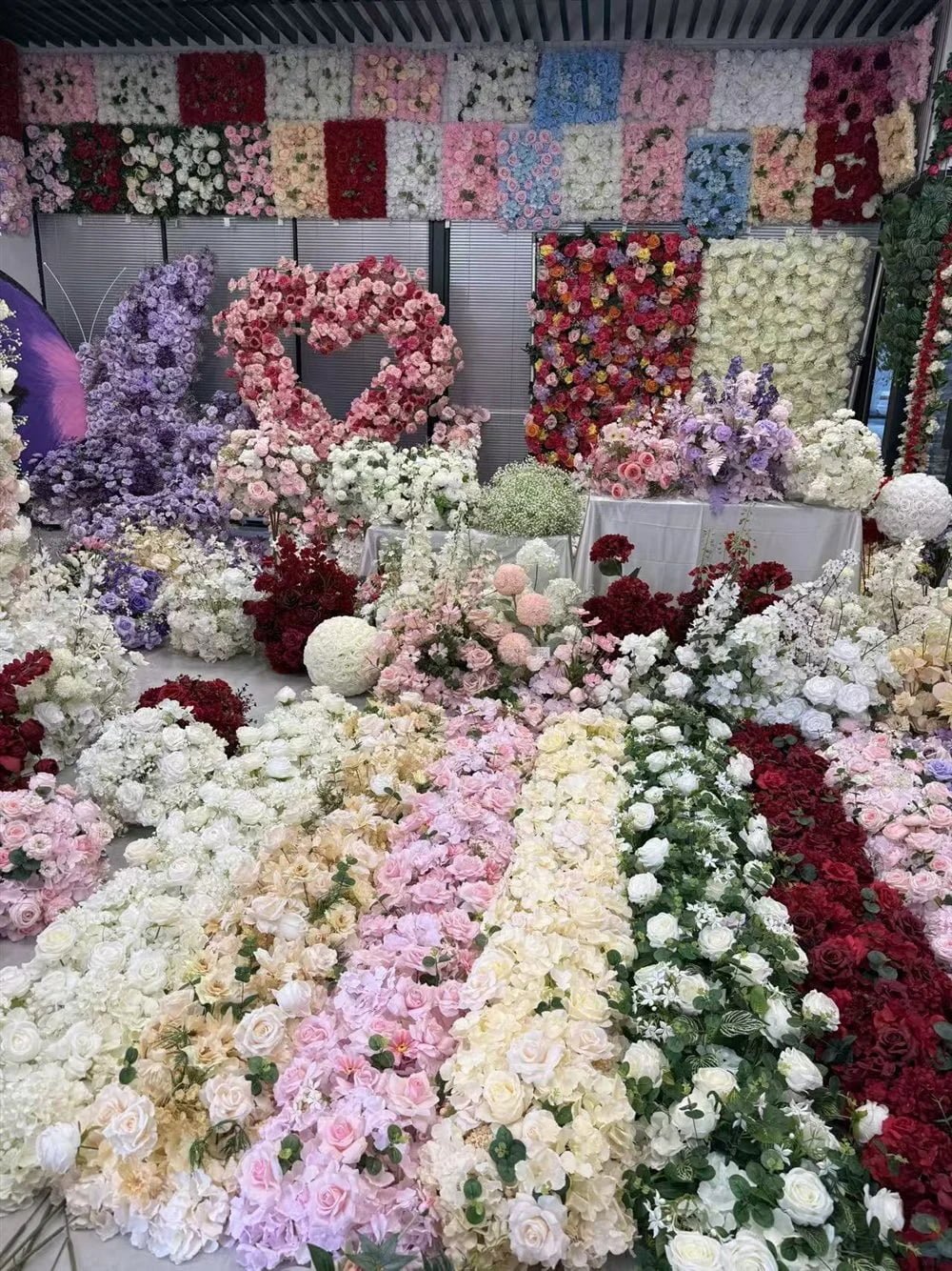 Artificial flower panels, heart-shaped flower arch and flower balls in the Botanicblossoms showroom