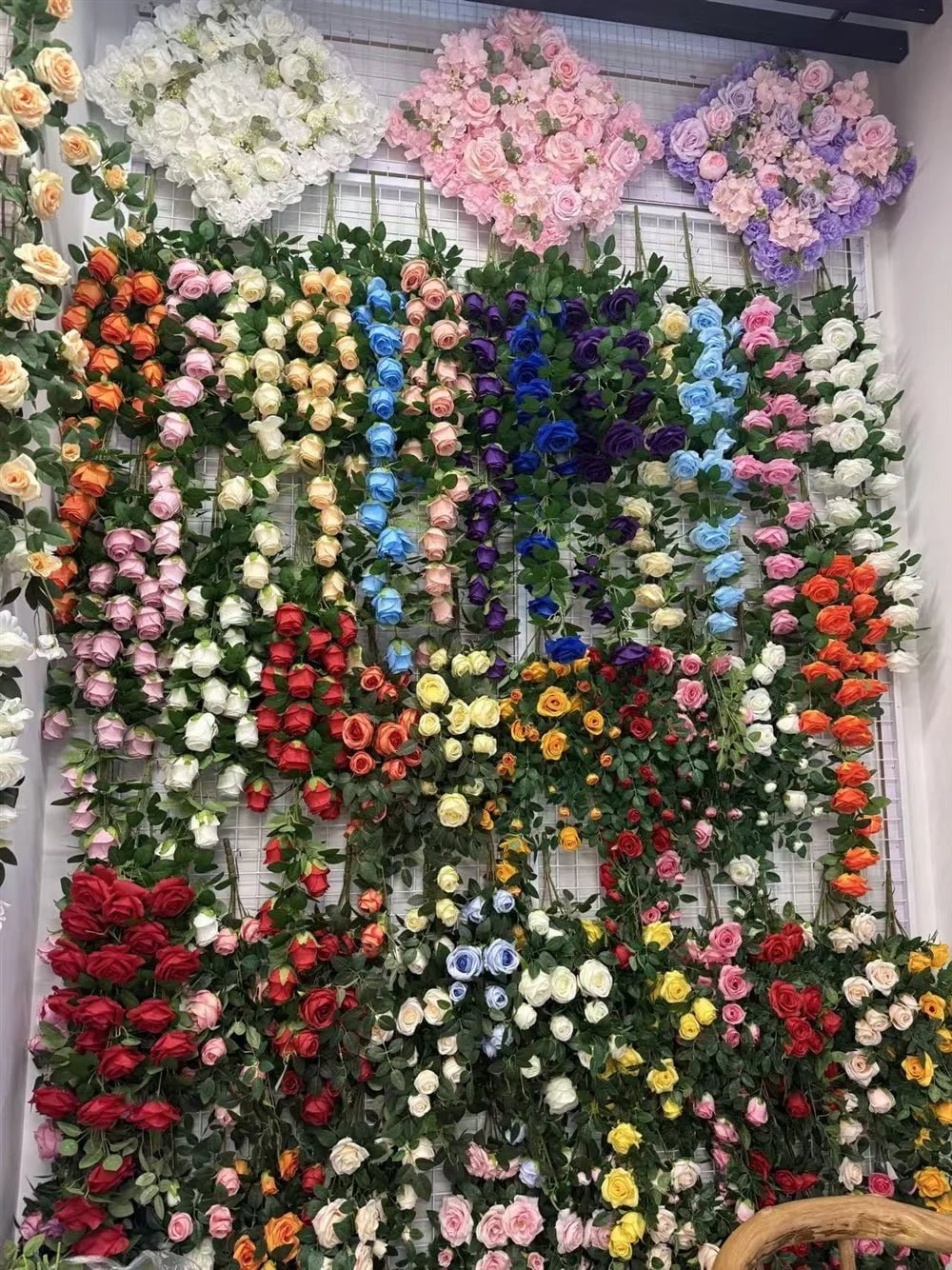 Wall of artificial rose garlands in many colors in the Botanicblossoms showroom
