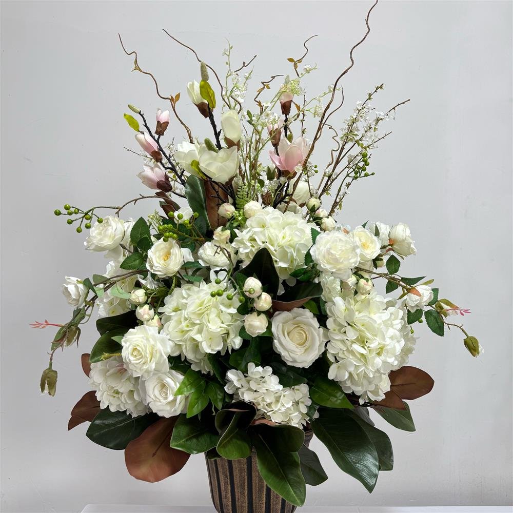 White hydrangea, rose and magnolia artificial flower arrangement with branches